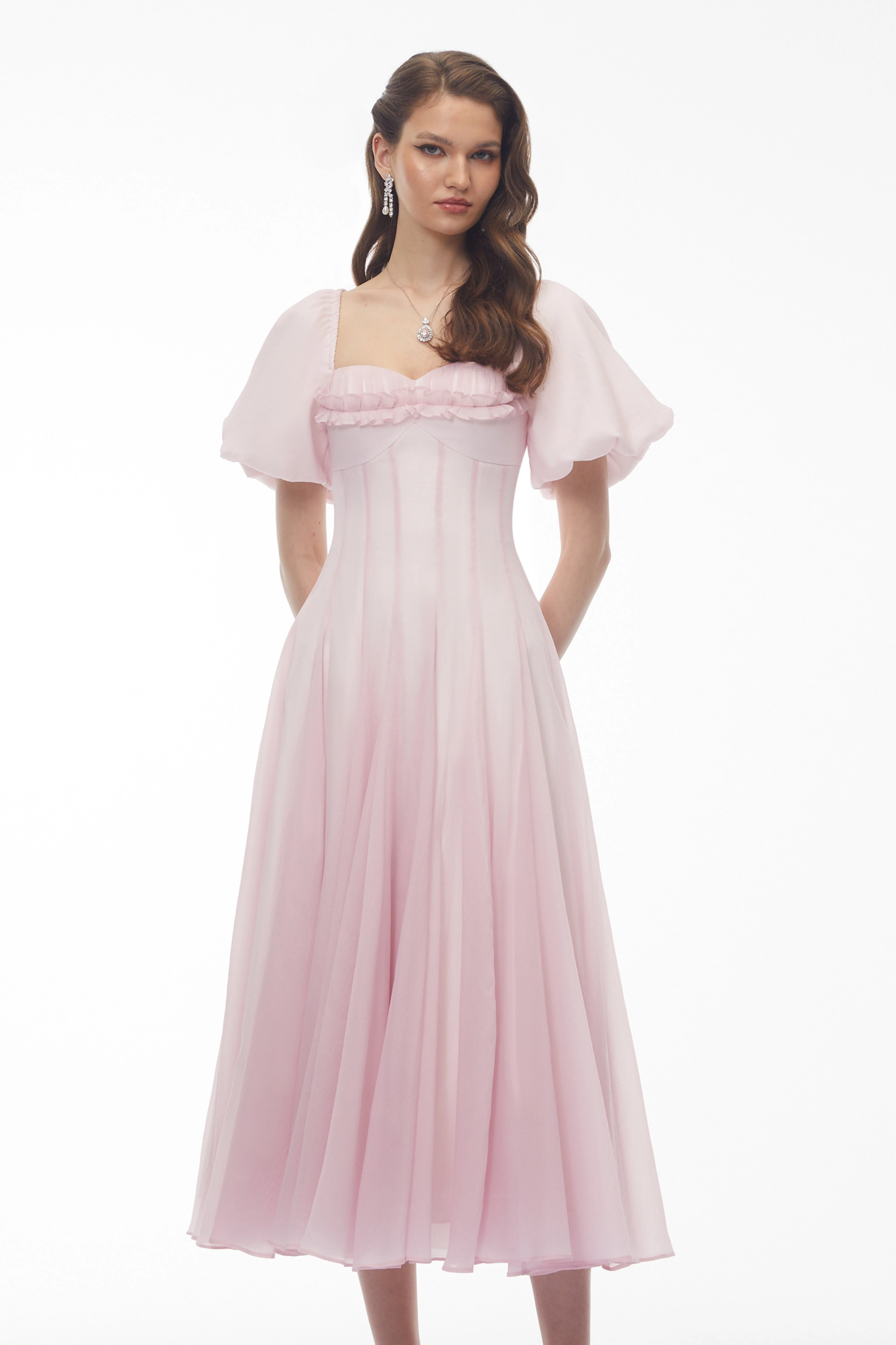Light pink midi dress with puff sleeves, a ruffled sweetheart neckline, and a pleated skirt