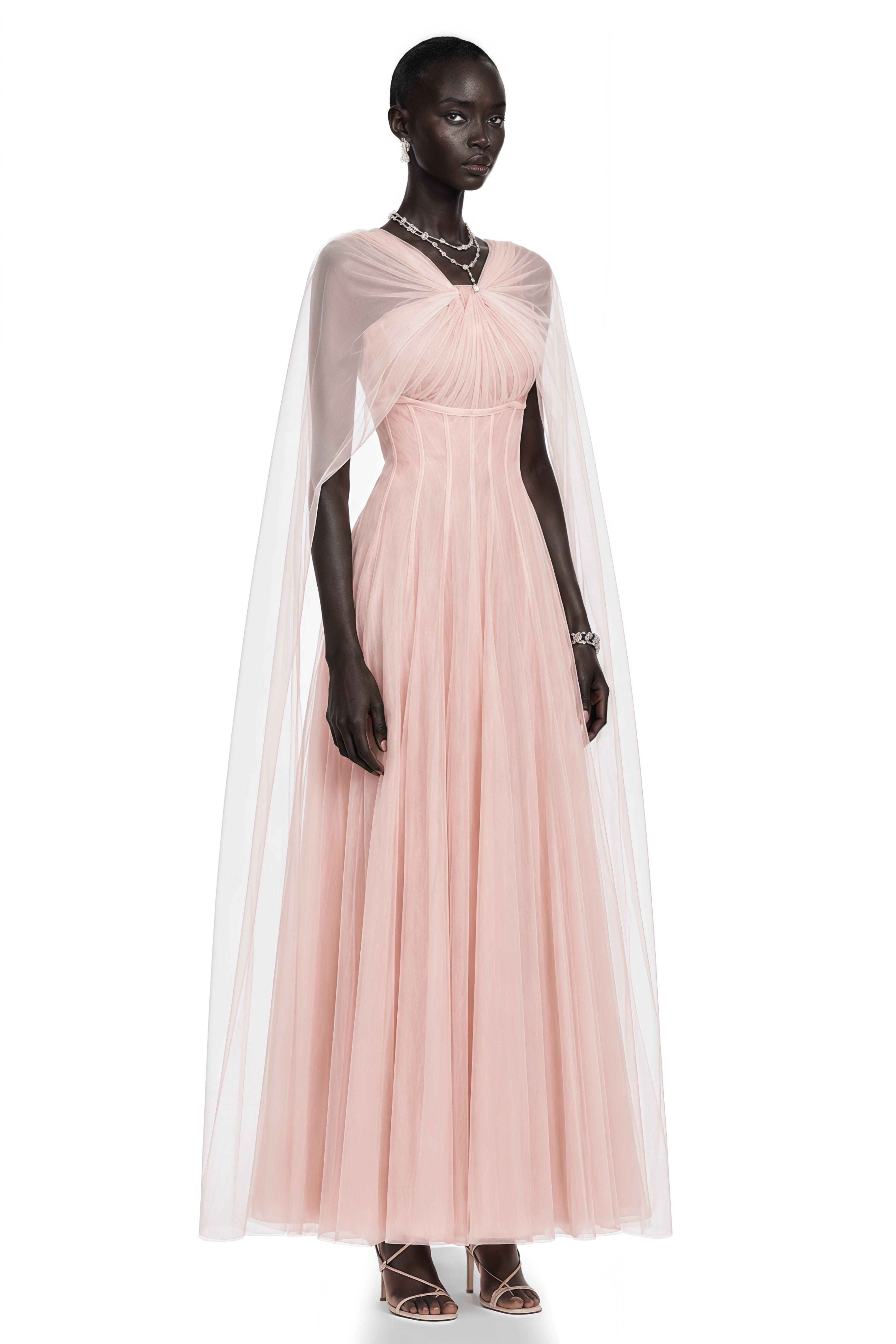 Light pink tulle gown with a corset bodice and matching sheer cape