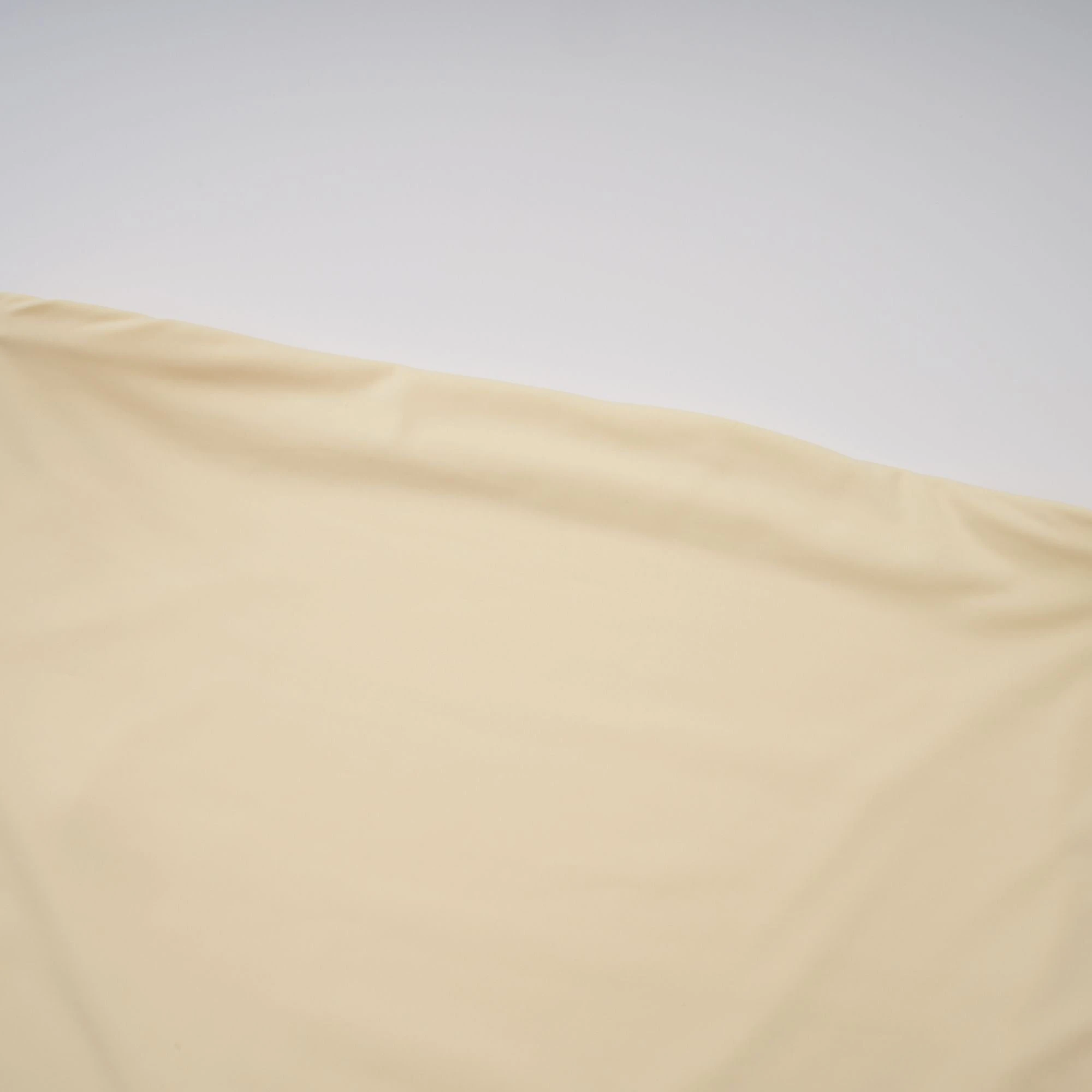 Pale yellow strapless gown with an asymmetrical bodice and pleated sheer skirt