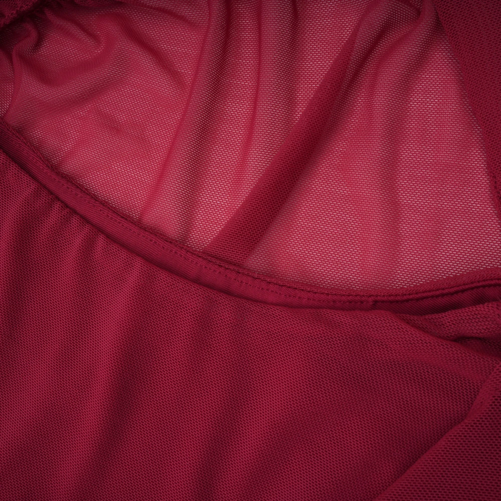 Burgundy ruched gown with a draped high neckline and sheer skirt