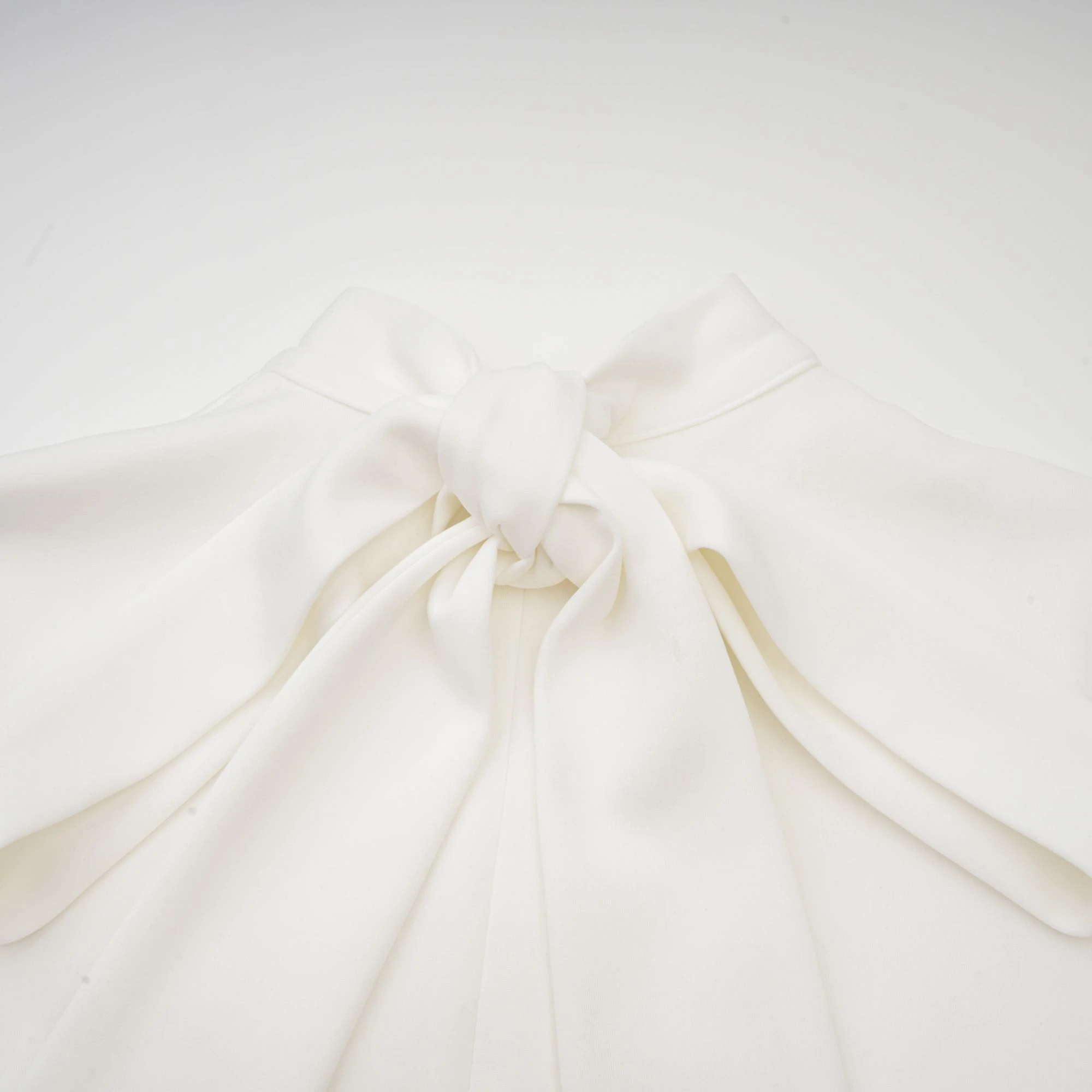 White sleeveless high-neck midi dress with 3D floral embellishments