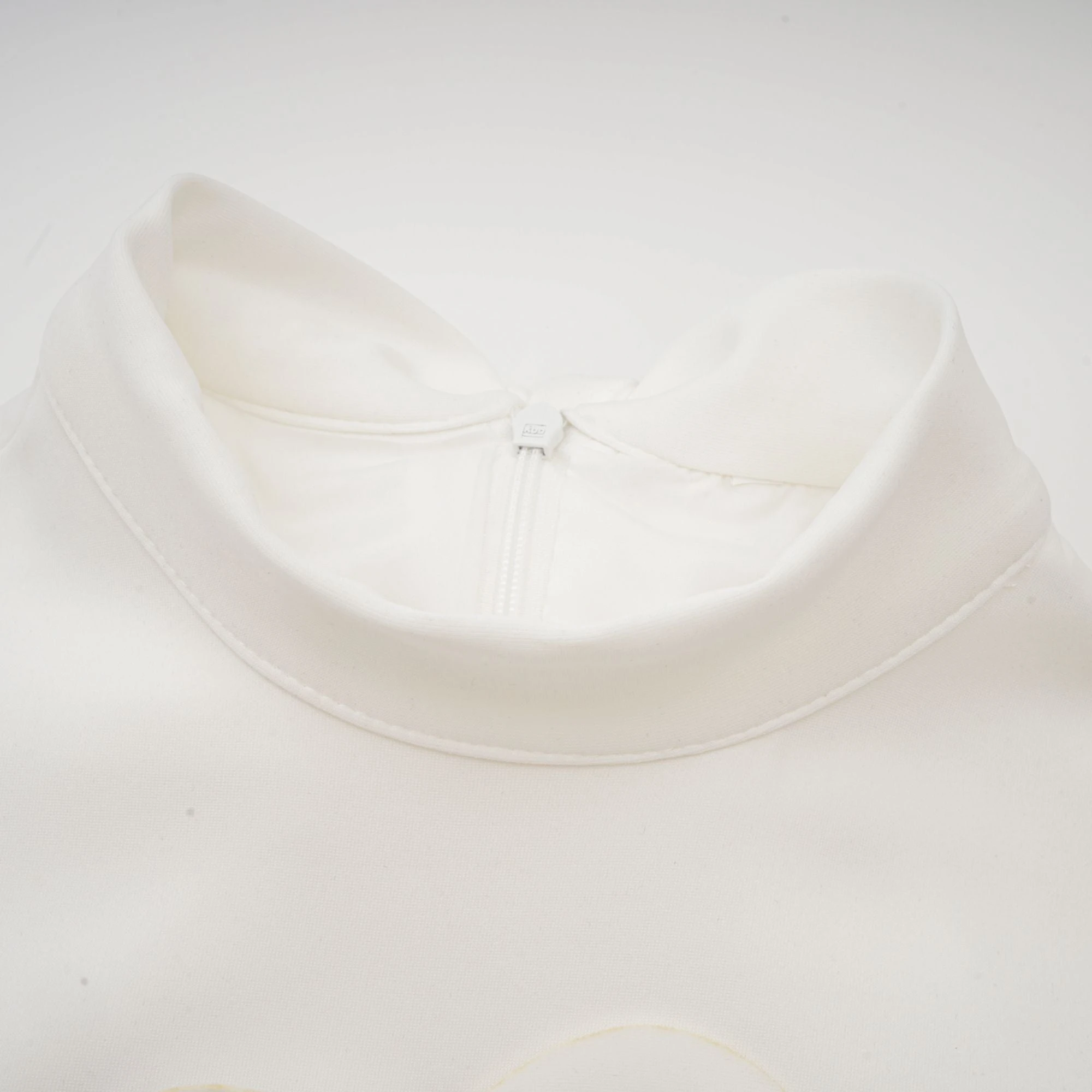 White sleeveless high-neck midi dress with 3D floral embellishments