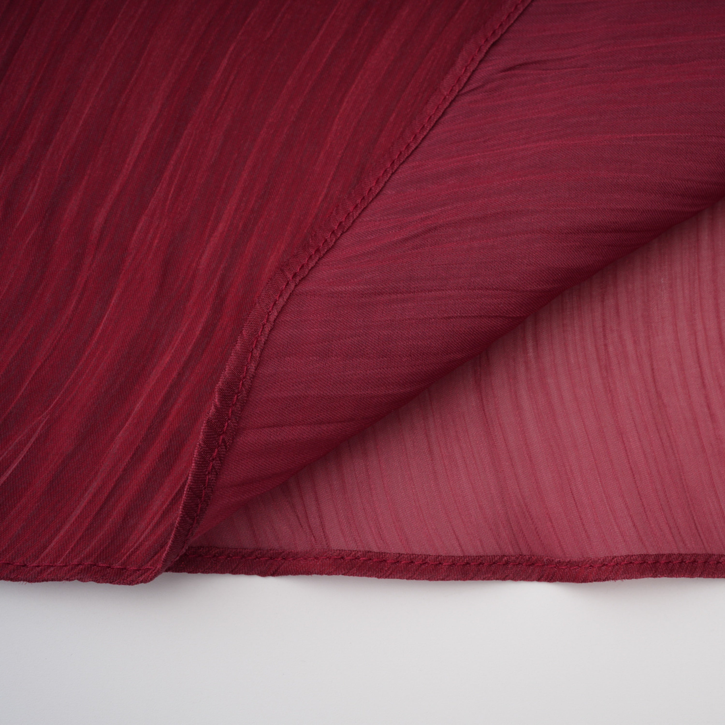 Burgundy pleated strapless gown with matching cape and high slit